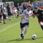 Senior Tommy Mead fends off a challenge on the way to a 2-1 win over Roanoke College on Sept. 16.