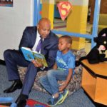 School Superintendent David White enjoys
a story with his book
buddy, first-grader
Paul Johnson III, in
King William County.