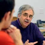 Stephen Farnsworth chats with a student during class.