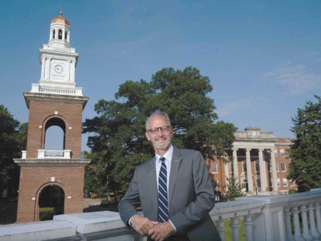 Troy D. Paino, 10th president of the University of Mary Washington, stands before George Washington Hall and the bell tower.
