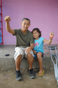 Shin Fujiyama '07 shares a moment with Abigail, 11, an orphanage resident undergoing treatment for a rare cancer.
