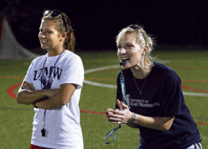 Lacrosse coach Caitlin Erickson Moore '08 (right) on the sidelines with assistant coach Lizzie Wright. Photo by Norm Shafer.