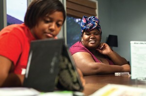 Ebony Dixon, right, received a Shawn Carter (aka Jay-Z) scholarship. Here, she and Brooke Turner watch video clips of UMW’s Voices of Praise gospel choir.  Scott Julian/The Free Lance–Star