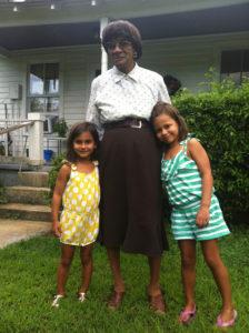 The author’s daughters, Selma and Amaya, stand with Elsie Lancaster, a longtime housekeeper for Green’s grandparents. During the school shutdown, Lancaster had to send her own daughter away from home to get an education.