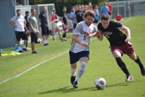 Senior Tommy Mead fends off a challenge on the way to a 2-1 win over Roanoke College on Sept. 16.