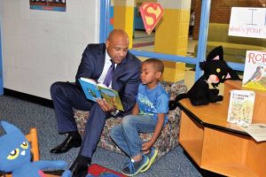 School Superintendent David White enjoys a story with his book buddy, first-grader Paul Johnson III, in King William County.