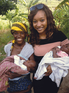Aissata Traore, shown here with a Rwandan Twa family, deferred  master’s studies to work in Rwanda.