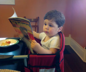 Cute Kid Reading Magazine