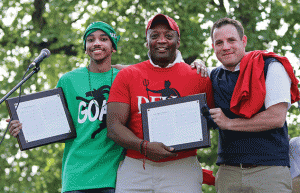 Corey Hewson (right) and Ronald May (left) wrote the lyrics to UMW's new fight song, Soar, Eagle Nation, Soar! Cedric Rucker ’81, dean of student life, presented awards for their efforts at Devil-Goat Day.  Photo by Norm Shafer